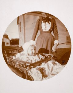 Baby in Carriage, Woman Standing Behind